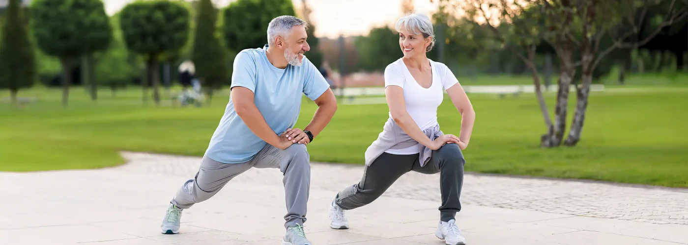 joyful senior husband and wife making sport outdoors 1400x500 crop center